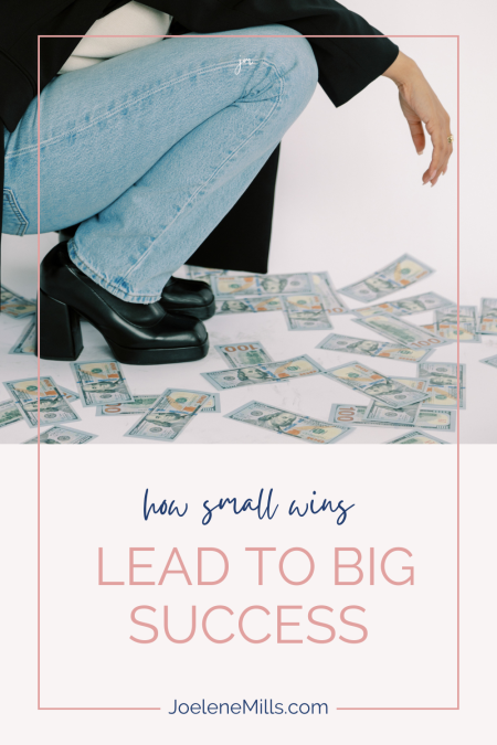 woman wearing jeans squatting over a pile of money with the words "how small wins lead to big success"