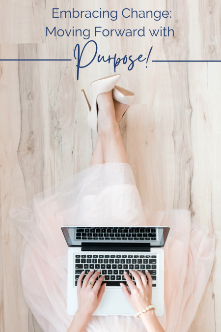 Woman working on her laptop, in a pink dress and heels, with the words Embrace Change: moving forward with purpose!