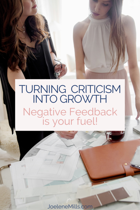 two women working together reviewing items on a table, with the words Turning Criticism into Growth