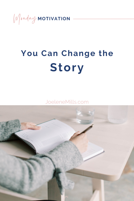 Woman journaling at a light wood desk with water nearby—symbolizing rewriting your story and starting fresh in business and life after 50. with the words "you can change the story" above.